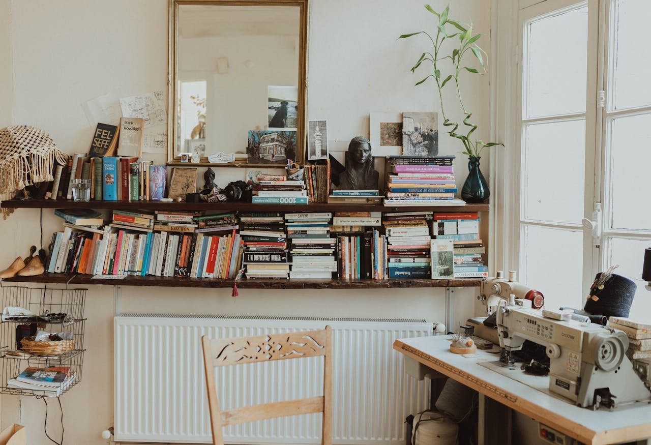Warm and inviting home office featuring a sewing machine, bookshelves, and vintage decor. Perfect for creative inspiration.