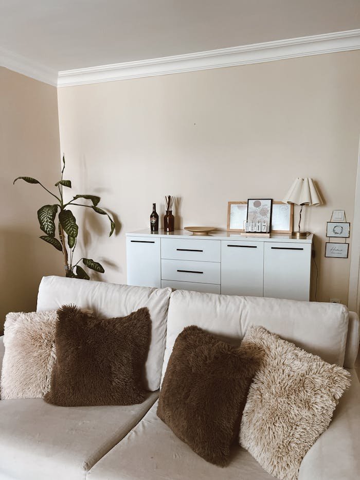 Inviting living room with neutral decor, plush cushions, and a minimalistic ambiance.